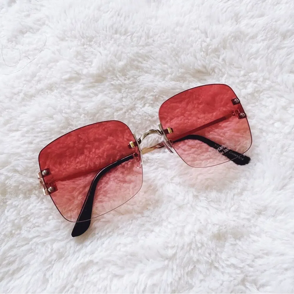 Laurel Clear Orange Rimless Sleek Sunglasses